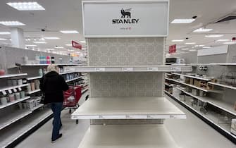 Canoga Park, CA - January 09: A shopper passes empty shelves once stocked with Stanley insulated steel tumblers at a Target store on Tuesday, Jan. 9, 2024 in Canoga Park, CA.  The Stanley cups, not the Stanley Cup awarded to the National Hockey League champion, has prompted long lines outside of Target stores in the dead of night.  Ugly fights have broken out.  Shouting matches have erupted.  All this hubbub over insulated steel tumblers sold in various colors at Target and Starbucks.  (Brian van der Brug / Los Angeles Times via Getty Images)