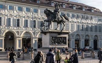 TURIN, ITALY - DECEMBER 07: People stroll around the equestrian monument of Emmanuel Philibert of Savoy (aka Caval ed bronz, Horse of bronze) in the central Piazza San Carlo, on December 07, 2023 in Turin, Italy. (Photo by Emanuele Cremaschi/Getty Images)