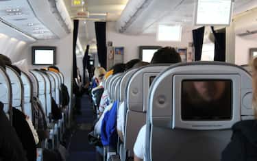 Passengers in aircraft wait for takeoff.