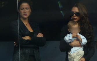 MADRID, SPAIN - SEPTEMBER 13: (FILE PHOTO)  Victoria Beckham holds son Romeo beside David Beckham's PA Rebecca Loos during the Spanish Primera Liga match between Real Madrid and Valladolid at the Santiago Bernabeu Stadium on September 13, 2003 in Madrid, Spain. David Beckham and former PA Rebecca Loos are under scrutiny for an alleged affair, reported by the News Of The World this weekend. (Photo by Shaun Botterill/Getty Images)