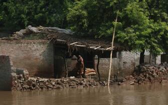 KASUR, PAKISTAN - AUGUST 21: A resident waits rescue workers in the house as the Pakistani rescue workers evacuate the people from flood waters in Kasur district of Punjab, Pakistan on August 21, 2023. Sutlej River surged to Ã¢extremely high levelsÃ¢Â  at Ganda Singh Wala Barrage on Saturday, resulting in the evacuation of hundreds of families from 72 villages in Kasur and Chunian, while three people drowned in floodwater in Kasur while trying to find higher groundc (Photo by Rana Irfan Ali/Anadolu Agency via Getty Images)