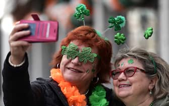 DUBLIN, IRELAND - MARCH 17: Two women pose for a photo during the St. Patrick's Day parade on March 17, 2024 in Dublin, Ireland. This year's theme of the parade is Spréach, the Irish word for Spark,  which is said to represent the unique essence of Ireland and its people. The parade starts at midday on Parnell Square North down then moves to O'Connell Street and crosses the River Liffey. (Photo by Charles McQuillan/Getty Images)