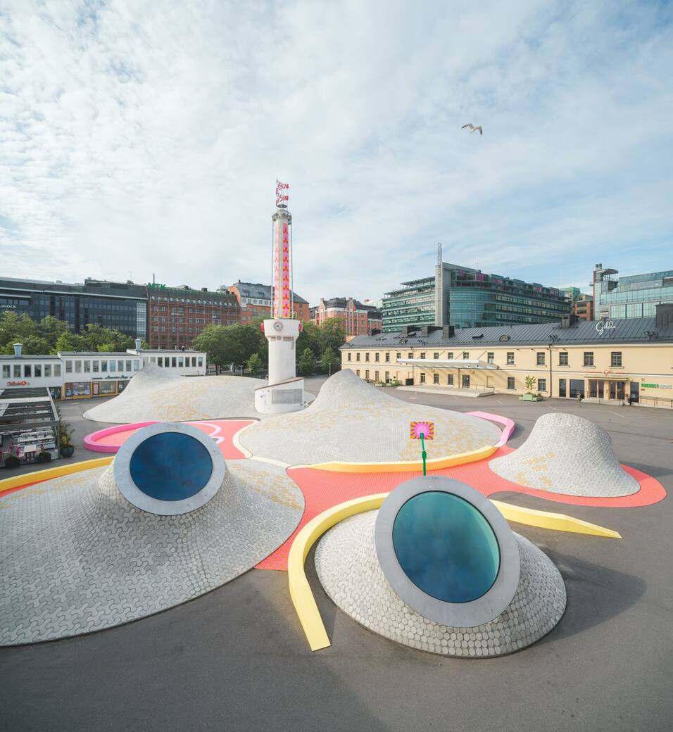 Yinka Ilori’s public artwork Transparent Happiness weaves its way around the Amos Rex mounds on Lasipalatsi Square. Photo: Mika Huisman / Amos Rex.