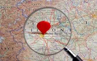 Red map pointer stuck into of Torino