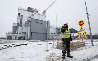 epa05685684 A worker stands next to the construction area of the Interim Spent Nuclear Fuel Dry Storage Facility (ISF-2) near the Chernobyl nuclear power plant,  in Chernobyl, Ukraine, 22 December 2016. The new protective shelter over the remains of the nuclear reactor Unit 4 will secure the affected fourth reactor. The shelter is over 105 metres tall and weighs 36,000 tons. The explosion of Unit 4 of the Chernobyl nuclear power plant in the early hours of 26 April 1986 is still regarded the biggest accident in the history of nuclear power generation.  EPA/ROMAN PILIPEY