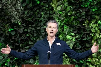 California Governor Gavin Newsom delivers a speech on stage during a press conference following his visit of a Covid-19 vaccination site at the Convention Center in Long Beach, South of Los Angeles, California, USA, 22 February 2021. ANSA/ETIENNE LAURENT
