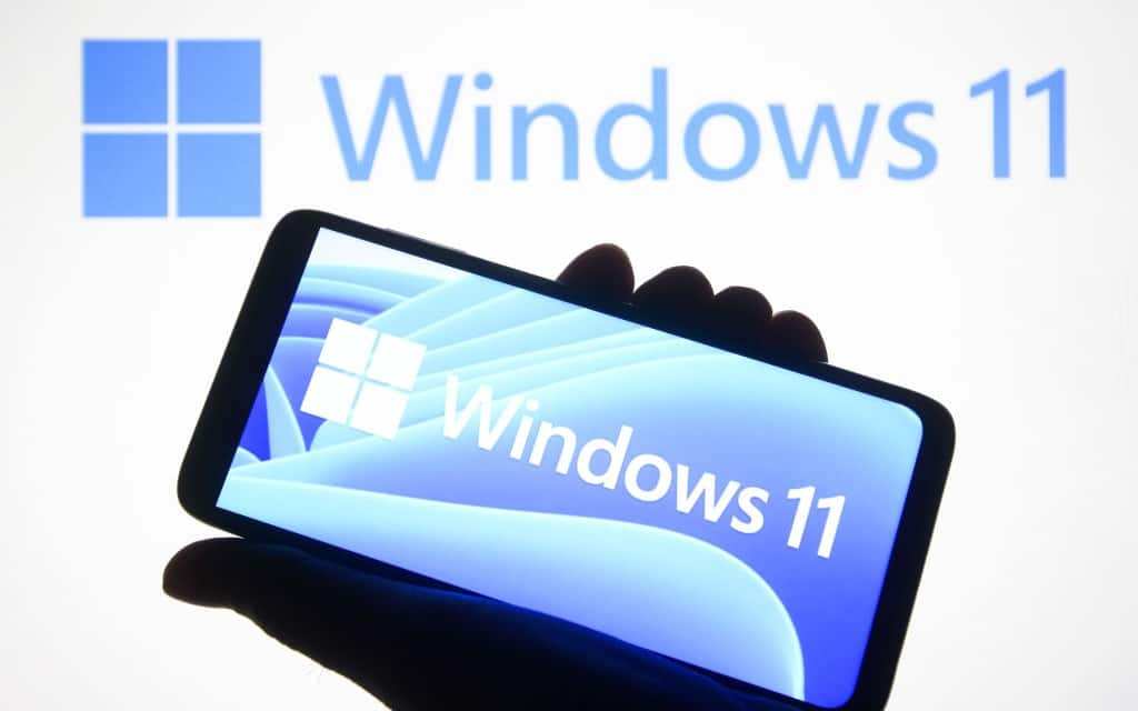 UKRAINE - 2021/06/24: In this photo illustration a Windows 11 logo is seen on a smartphone and a pc screen in the background.
Microsoft has presented Windows 11, new generation of Windows operating system (OS), during an event on June 24, 2021. (Photo Illustration by Pavlo Gonchar/SOPA Images/LightRocket via Getty Images)