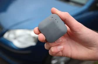 A young driver about to install a UK car insurance telematics black box into his new car.