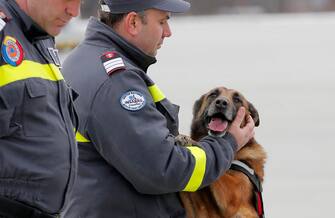 epa10451077 A Romanian rescue worker (C) and his special trained rescue dog (R) attend a last briefing before being deployed to Southern Turkey to help local authorities in their rescue missions after the devastating earthquake that hit Turkey and Syria, at the military airbase no. 90, in Otopeni, near Bucharest, Romania, 06 February 2023. Two Romanian military aircraft will take 58 rescuers and 4 specialized dogs to Turkey, as well as the materials necessary for their mission, which will support the efforts of the Turkish authorities to search for survivors in the areas affected by the latest earthquakes. According to the US Geological Service, an earthquake with a preliminary magnitude of 7.8 struck southern Turkey close to the Syrian border. The earthquake caused buildings to collapse and sent shockwaves over northwest Syria, Cyprus, and Lebanon.  EPA/ROBERT GHEMENT