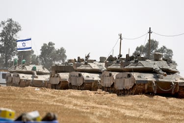 epa11312278 Israeli soldiers with military vehicles gather at a position on the southern Israeli border with the Gaza Strip, near the Palestinian city of Rafah, 01 May 2024. More than 34,300 Palestinians and over 1,455 Israelis have been killed, according to the Palestinian Health Ministry and the Israel Defense Forces (IDF), since Hamas militants launched an attack against Israel from the Gaza Strip on 07 October 2023, and the Israeli operations in Gaza and the West Bank which followed it.  EPA/ATEF SAFADI