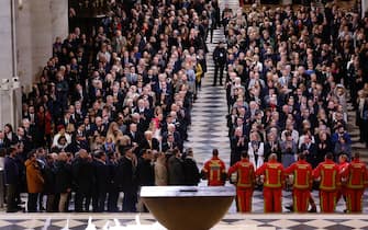 Guests applaud firefighters, rescuers and builders involved in the restoration of Notre-Dame Cathedral during a ceremony to mark the re-opening of landmark cathedral, in central Paris, on December 7, 2024. Around 50 heads of state and government are expected in the French capital to attend the ceremony marking the rebuilding of the Gothic masterpiece five years after the 2019 fire which ravaged the world heritage landmark and toppled its spire. Some 250 companies and hundreds of experts were part of the five-year restoration project at a cost of hundreds of millions of euros. (Photo by Ludovic MARIN / POOL / AFP)