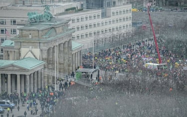15 January 2024, Berlin: Demonstrators stand at the Brandenburg Gate during the Farmers' Action Week. The protests are directed against planned subsidy cuts by the federal government, including for agricultural diesel. Photo: Kay Nietfeld/dpa (Photo by Kay Nietfeld/picture alliance via Getty Images)