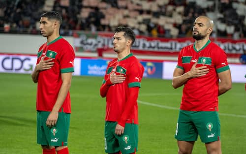 epa11237738 Moroccan players Achraf Hakimi (L), Brahim Diaz (C), and Youssef Lekhedim (R) in salute to the Moroccan flag during the friendly international soccer match between Morocco and Angola in Agadir, Morocco, 22 March 2024.  EPA/JALAL MORCHIDI