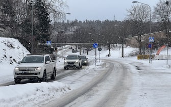 STOCKHOLM, SWEDEN - JANUARY 03: Cars move on the snow covered road during the frosty weather in Stockholm, Sweden on January 03, 2024. Today was recorded as 'the coldest day in January in Sweden in the last 25 years' while temperatures in the Scandinavian region fell below minus 40 degrees centigrade for two consecutive days. (Photo by Atila Altuntas/Anadolu via Getty Images)