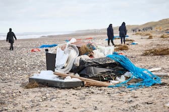 epa11044609 Locals inspect items from containers spillage  along the West coast at Tranum beach in North Jutland, Denmark, 26 December 2023. The contents of 46 lost containers from the ship Mayview Maersk wash ashore in North Jutland. The containers washed overboard during storm Pia.  EPA/Claus Bjoern Larsen  DENMARK OUT