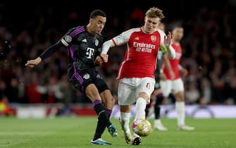 epa11268187 Martin Odegaard (R) of Arsenal in action against Jamal Musiala of Bayern during the UEFA Champions League quarter-finals, 1st leg soccer match between Arsenal FC and FC Bayern Munich, in London, Britain, 09 April 2024.  EPA/ANDY RAIN