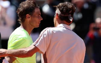epa07632976 Rafael Nadal of Spain (L) reacts with Roger Federer of Switzerland after winning their menâs semi final match during the French Open tennis tournament at Roland Garros in Paris, France, 07 June 2019.  EPA/SRDJAN SUKI