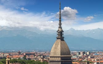 Turin, Piedmont, Italy - cityscape seen from above with the Mole Antonelliana architecture symbol of the city of Turin, in the background the Alps wit