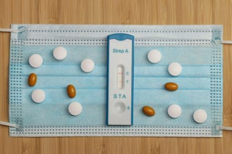 A quick test for group A streptococci with a positive result lies on a surgical face mask. These bacteria cause diseases tonsillitis and scarlet fever.