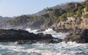 Strong sea waves breaking on coast rocks with splashes, Lerici, Liguria, Italy