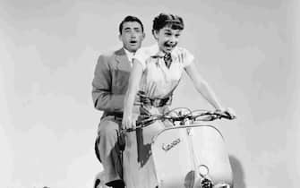 Gregory Peck and Audrey Hepburn practice a moped scene for the 1953 comedic romance Roman Holiday, in which Peck plays the role of journalist Joe Bradley and Audrey Hepburn as Anya Smith, aka Princess Ann, who has run away from her life of royalty. (Photo by �� John Springer Collection/CORBIS/Corbis via Getty Images)