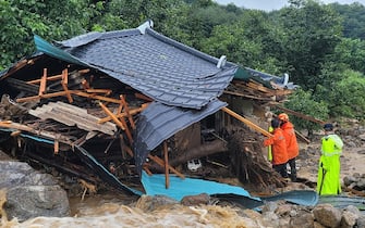 GYEONGSANGBUK-DO, SOUTH KOREA - JULY 15: (EDITORIAL USE ONLY) In this handout image provided by the Gyeingbuk Fire Servise Headquarters via Dong-A Daily, South Korean emergency workers searching for survivors at a house destroyed by flood waters after heavy rains in North Gyeongsang Province on July 15, 2023 in Gyeongsangbuk-do, South Korea. At least twelve people have died and ten have gone missing amid torrential rains that have flooded many parts of South Korea, forcing thousands of people to evacuate from homes. (Photo by Gyeingbuk Fire Servise Headquarters/Dong-A Daily via Getty Images)