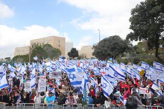 epa10545123 Protesters gather outside the Knesset ahead of mass protests in Jerusalem, Israel, 27 March 2023. Mass protests have been held in Israel for 12 weeks against the government's plans to reform the justice system and limit the power of the Israeli Supreme Court.  EPA/ABIR SULTAN