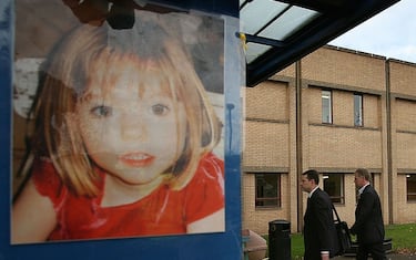 LEICESTER, UNITED KINGDOM - NOVEMBER 01:  Gerry McCann (L), escorted by his advisor Clarence Mitchell, walks past a poster of his missing daughter as he returns for work at Glenfield Hospital,  where he is a consultant cardiologist on November 1, 2007, in Leicester, England. Mr  McCann returns to work six months after the disappearance of daughter Madeleine, who vanished from their hoiliday apartment in Praia da Luz, Portugal, on May 3, 2007.  (Photo by Christopher Furlong/Getty Images)