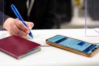 Employee checking documents, issuing boarding pass