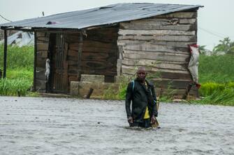 epa10515412 A man walks on a flooded street near Quelimane, as the storm Freddy hits in Quelimane, Mozambique, 11 March 2023. The provincial capital of Quelimane will be the largest urban area closest to the cyclone's point of arrival on the mainland, and its radius (of about 300 kilometres) is expected to extend from Marromeu to Pebane, then moving inland towards Cherimane and southern Malawi. This is one of the longest lasting storms ever, after it formed at the beginning of February in the Asian seas, crossing the entire Indian Ocean to the east African coast.  EPA/ANDRÉ CATUEIRA