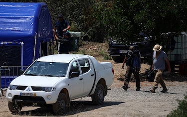Portuguese Judicial Police (PJ) criminal investigation unit members leave the base camp set near the Arade dam in Silves on May 25, 2023, after the search operation in the investigation into the disappearance of Madeleine McCann (Maddie) has been declared over. Portuguese Judicial Police focus on an area cordoned off around the Arade reservoir, nearly 50 kilometres (30 miles) from where the then three-year-old Maddie went missing in the Algarve tourist resort of Praia da Luz in May 2007. Portuguese media said today's search of the banks of the Arade dam could be the last in the three-day operation, which has involved around 50 police officers and Portuguese firefighters. (Photo by FILIPE AMORIM / AFP) (Photo by FILIPE AMORIM/AFP via Getty Images)