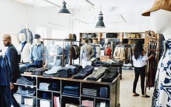 Shoppers looking at items in mens clothing boutique