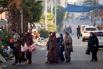 Palestinians flee to safer areas in Gaza City after Israeli air strikes, on October 13, 2023. Israel has called for the immediate relocation of 1.1 million people in Gaza amid its massive bombardment in retaliation for Hamas's attacks, with the United Nations warning of "devastating" consequences. (Photo by MAHMUD HAMS / AFP) (Photo by MAHMUD HAMS/AFP via Getty Images)