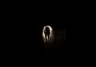 TOPSHOT - A member of the Palestinian Islamic Jihad militant group enters a tunnel in the Gaza strip, on April 17, 2022, during a media tour amid escalating violence with Israel. - More than 20 Palestinians and Israelis were wounded in several incidents in and around Jerusalem's flashpoint Al-Aqsa Mosque complex, two days after major violence at the site. (Photo by Mahmud HAMS / AFP) (Photo by MAHMUD HAMS/AFP via Getty Images)