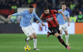Lazioâ&#x80;&#x99;s Spanish defender Mario Gila challenges for the ball with Milan's French forward Olivier Giroud during the Serie A football match SS Lazio vs AC Milan at Olimpico Stadium on March 01, 2024, in Rome.