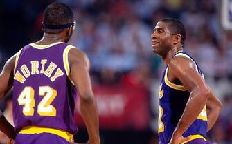INGLEWOOD, CA - 1991:  James Worthy #42 and Magic Johnson #32 of the Los Angeles Lakers talk during a game circa 1991 at the Great Western Forum in Inglewood, California. NOTE TO USER: User expressly acknowledges and agrees that, by downloading and/or using this Photograph, user is consenting to the terms and conditions of the Getty Images License Agreement. Mandatory Copyright Notice: Copyright 1991 NBAE (Photo by Andrew D. BernsteinNBAE via Getty Images)