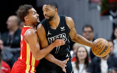 ATLANTA, GEORGIA - NOVEMBER 22: Mikal Bridges #1 of the Brooklyn Nets works against Trae Young #11 of the Atlanta Hawks during the first half at State Farm Arena on November 22, 2023 in Atlanta, Georgia. NOTE TO USER: User expressly acknowledges and agrees that, by downloading and or using this photograph, User is consenting to the terms and conditions of the Getty Images License Agreement. (Photo by Alex Slitz/Getty Images)