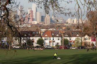 Infront of Lambeth homes and the skyline of Nine Elms, Battersea in the distance, an council employee marks the white lines on a football pitch in Ruskin Park, a public green space used for local, youth and amateur league matches, on 29th November 2023, in London, England. (Photo by Richard Baker / In Pictures via Getty Images)