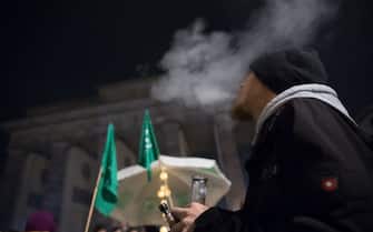 BERLIN, GERMANY - APRIL 01: Cannabis enthusiasts smoke joints legally at the Brandenburg Gate at shortly after midnight on April 1, 2024 in Berlin, Germany. Germany's new cannabis law goes into effect today, bringing in a new era of legal cannabis consumption. Cannabis social clubs will also be allowed to grow their own marijuana beginning later this year.(Photo by Michele Tantussi/Getty Images)