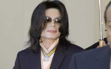 epa000401538 Michael Jackson (L) leaves Santa Barbara county courts with his father Joe in Santa Maria, California, Wednesday 30 March 2005. The mother of Michael Jackson's accuser refused an offer of money after the broadcast of a documentary featuring the pop star and her son, a witness said, as prosecutors sought to counter claims that her greed was behind the sex-abuse charges. Jackson, 46, is charged with molesting the woman's son, then 13, at Neverland and plying the boy with alcohol in order to abuse him.  EPA/JOSHUA GATES WEISBERG