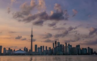 TORONTO, CANADA - JULY 1:  The downtown skyline is viewed after sunset from Centre Island in Toronto Harbour on July 1, 2014 in Toronto, Ontario, Canada. Canada's most populous city is undergoing a major economic boom with high-rise construction and renovation projects underway throughout the downtown and outlying neighborhoods. (Photo by George Rose/Getty Images)