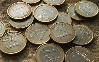 European money. Poured 1 Euro coins on natural linen fabric.