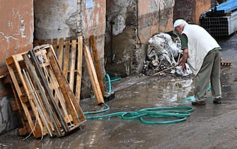 Operai di una ditta edile al lavoro per liberare scantinati dall'acqua, dopo il nubifragio della notte a causa della pioggia, Genova, 28 agosto 2023.
ANSA/LUCA ZENNARO