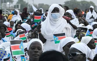 Attendees hold South Sudan flags ahead of the holy mass with Pope Francis at the John Garang Mausoleum in Juba, South Sudan, on February 5, 2023. - Pope Francis wraps up his pilgrimage to South Sudan with an open-air mass on February 5, 2023 after urging its leaders to focus on bringing peace to the fragile country torn apart by violence and poverty.
The three-day trip is the first papal visit to the largely Christian country since it achieved independence from Sudan in 2011 and plunged into a civil war that killed nearly 400,000 people. (Photo by Simon MAINA / AFP) (Photo by SIMON MAINA/AFP via Getty Images)
