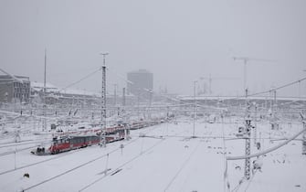 epa11007118 A view of snow-covered trains parked at Munich central station in Munich, Germany, 02 December 2023. Due to heavy snowfall, flight operations at Munich Airport have been temporarily suspended until 03 December at 6 a.m., the airport announced. Several railway lines around Bavaria's state capital Munich had to be closed overnight, Deutsche Bahn (DB) said. Snowfall is expected to continue throughout the day in south and southeast Germany with as much as 20 to 40 cm of snow covering some areas of Bavaria, followed by frost and partly slippery conditions, the German Meteorological Service (DWD) warned.  EPA/ANNA SZILAGYI