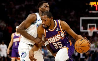 MINNEAPOLIS, MINNESOTA - APRIL 14: Kevin Durant #35 of the Phoenix Suns drives to the basket against Anthony Edwards #5 of the Minnesota Timberwolves in the first quarter at Target Center on April 14, 2024 in Minneapolis, Minnesota. NOTE TO USER: User expressly acknowledges and agrees that, by downloading and or using this photograph, User is consenting to the terms and conditions of the Getty Images License Agreement. (Photo by David Berding/Getty Images)