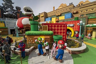 Guests pose with Mario and Luigi characters during a media preview of Super Nintendo World theme park at Universal Studios Hollywood in Universal City, California, US, on Thursday, Feb. 16, 2023. The interactive replica of Nintendo Co.'s lands and characters will open to the public on February 17. Photographer: Kyle Grillot/Bloomberg via Getty Images