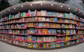 Cuneo, Italy - November 30, 2022: books for kids and children displayed on shelves of large Italian supermarket with discounted prices