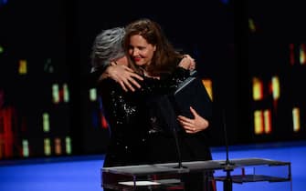 French film director Justine Triet (R) embraces US actress Jane Fonda (L) after she won the Palme d'Or for the film "Anatomie d'une Chute" (Anatomy of a Fall) during the closing ceremony of the 76th edition of the Cannes Film Festival in Cannes, southern France, on May 27, 2023. (Photo by CHRISTOPHE SIMON / AFP) (Photo by CHRISTOPHE SIMON/AFP via Getty Images)