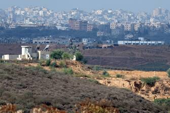 epa10974382 An Israeli army post overlooks the border with Gaza as Israeli army tents sit in the background near Beit Hanoun, in the northern Gaza Strip, as seen from Sderot, southern Israel, 14 November  2023. More than 11,100 Palestinians and at least 1,200 Israelis have been killed, according to the Israel Defense Forces (IDF) and the Palestinian health authority, since Hamas militants launched an attack against Israel from the Gaza Strip on 07 October, and the Israeli operations in Gaza and the West Bank which followed it. Over the past day, the Israeli Air Force (IAF) struck 200 targets as part of its 'ground operations' in the Gaza Strip, the IDF announced on 14 November.  EPA/ATEF SAFADI